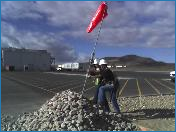 Red flag pole in rocks